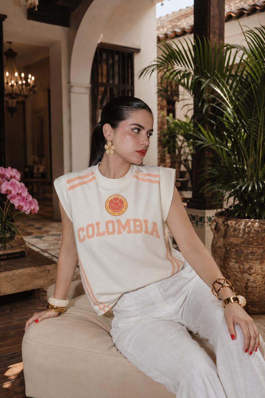 It Girl Colombia Sport oversize tee styled with white linen pants in Cartagena courtyard — May Palomino